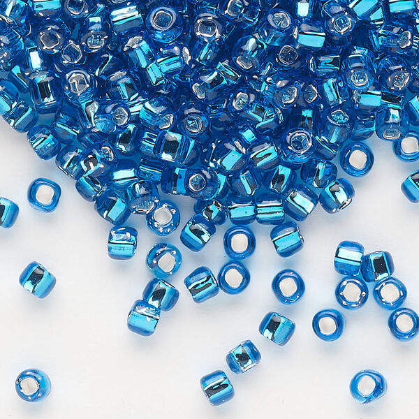 Seed bead, Dyna-Mites™, glass, silver-lined translucent turquoise blue, #6 round with square hole. Sold per 1/2 kilogram pkg. image number 0