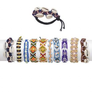 Bracelet mix, wood (dyed) / gold-ringer cowrie shell (natural) / nylon cord / polymer clay / plastic / glass, multicolored, promise style, adjustable from 6-9 inches with macramé knot closure. Sold per pkg of 10.