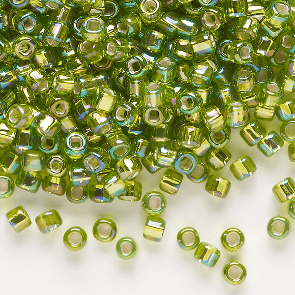 Seed bead, Dyna-Mites™, glass, silver-lined translucent rainbow light green, #6 round with square hole. Sold per 40-gram pkg. image number 0