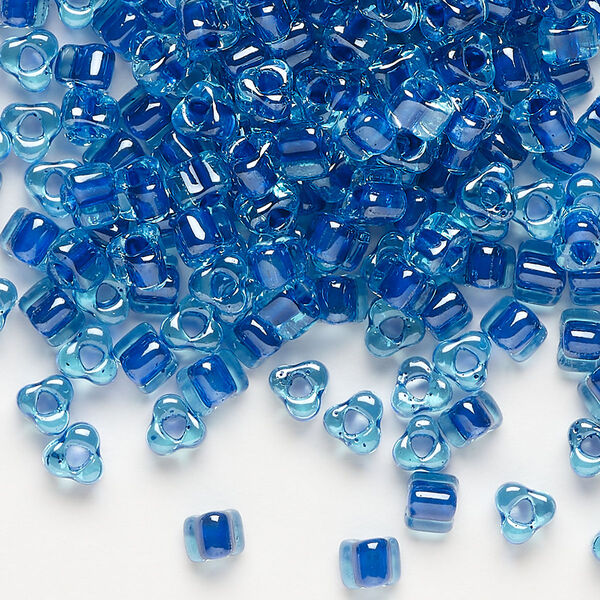 Seed bead, Miyuki, glass, transparent light blue color-lined dark blue, (TR1828), #5 triangle. Sold per 250-gram pkg. image number 0