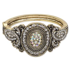 Bracelet, hinged bangle, glass rhinestone / antique gold-finished steel / "pewter" (zinc-based alloy), clear and clear AB, 41mm wide with oval and loop design, 6 inches. Sold individually.
