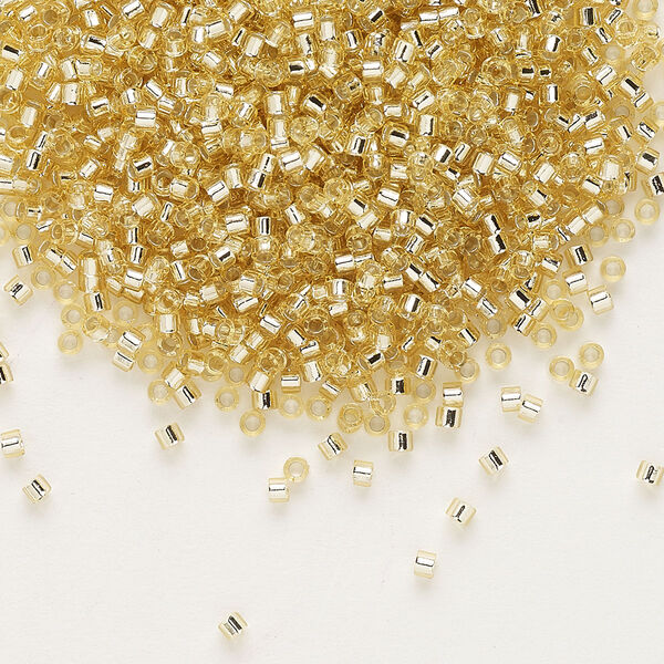 Seed bead, Delica®, glass, pkg/50g, #11 round, transparent silver-lined pale topaz (DB-1212). image number 0