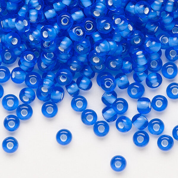 Seed bead, Preciosa Ornela, glass, transparent chalkwhite-lined sapphire, #6 rocaille. Sold per 50-gram pkg. image number 0
