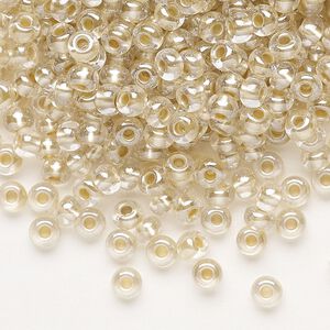 Seed bead, Preciosa Ornela, glass, translucent mocca pearl-lined crystal clear, #6 rocaille. Sold per 500-gram pkg.