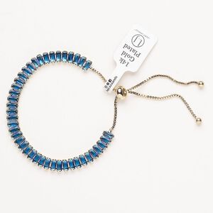 Bracelet, adjustable, brass / glass / silicone, pkg/1, 6 to 10 inches, gold plate and blue topaz.
