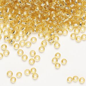 Seed bead, Dyna-Mites™, glass, silver-lined translucent light gold, #8 round. Sold per 1/2 kilogram pkg.
