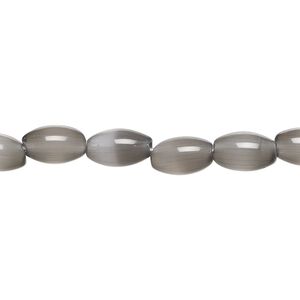 Bead, cat's eye glass (fiber optic glass), opaque black, 9x6mm oval, quality grade. Sold per 15-1/2" to 16" strand.