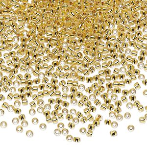 Seed bead, TOHO BEADS®, glass, pkg/50g, #11 round, transparent 24Kt gold-lined crystal clear (TR-11-701).
