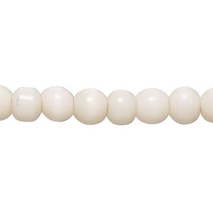 Bead, cat's eye glass (fiber optic glass), soft pink, 5-7mm round. Sold per 14-inch strand, approximately 55 beads.