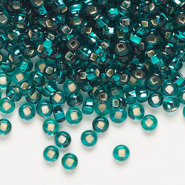 Seed bead, Preciosa Ornela Czech glass, pkg/500g, #6 rocaille, transparent silver-lined teal, (57710). image number 0