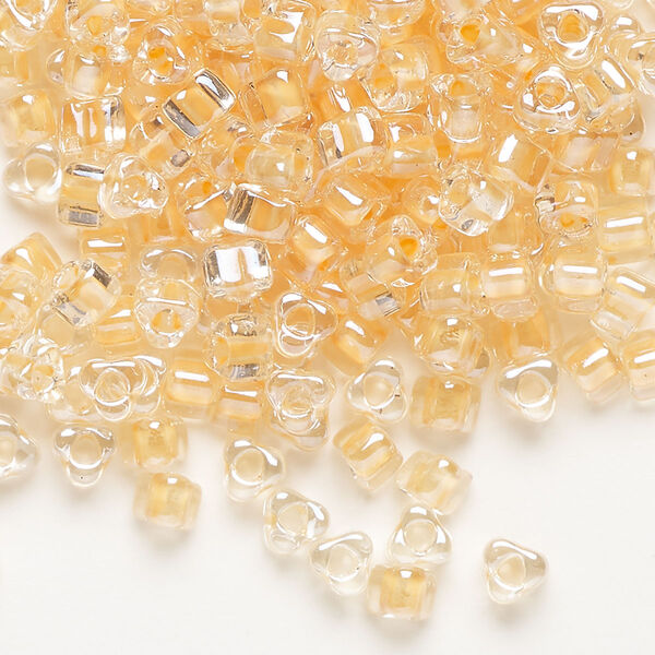Seed bead, Miyuki, glass, transparent clear color-lined tawny, (TR1131), #5 triangle. Sold per 25-gram pkg. image number 0