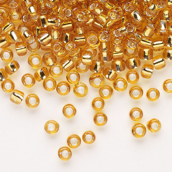 Seed bead, Dyna-Mites™, glass, transparent silver-lined gold, #6 round. Sold per 40-gram pkg. image number 0