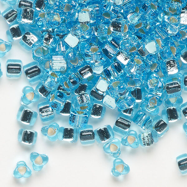 Seed bead, Miyuki, glass, silver-lined translucent light blue, (TR1803), #5 triangle. Sold per 250-gram pkg. image number 0