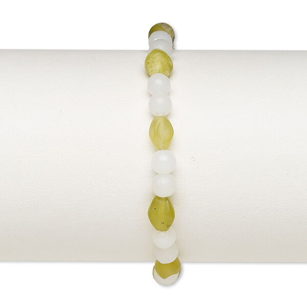 Bracelet, stretch, olive new "jade" (natural) and acrylic, white, 5mm round and 8x6mm-9x7mm oval, 7 inches. Sold individually. image number 0