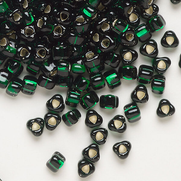 Seed bead, Miyuki, glass, silver-lined translucent dark green, (TR1806), #5 triangle. Sold per 250-gram pkg. image number 0