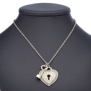 Necklace, glass rhinestone with gold-finished steel and "pewter" (zinc-based alloy), clear, 30x13mm key with 40x36mm heart lock, 18 inches with 2-inch extender chain and lobster claw clasp. Sold individually.