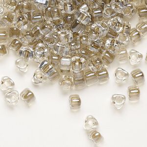 Seed bead, Miyuki, glass, transparent clear color-lined tan, (TR1124), #5 triangle. Sold per 250-gram pkg.
