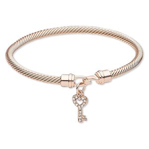 Bracelet, bangle, Czech glass rhinestone with copper-plated "pewter" (zinc-based alloy) and brass, clear, 4mm twisted cable with 16x8mm key, 7-1/2 inches with hook-and-eye clasp. Sold individually.