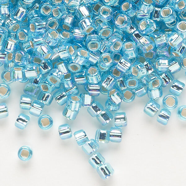 Seed bead, Dyna-Mites™, glass, silver-lined translucent rainbow light aqua, #6 round with square hole. Sold per 40-gram pkg. image number 0