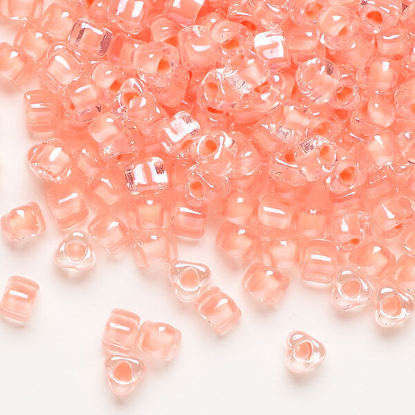 Seed bead, Miyuki, glass, transparent clear color-lined salmon, (TR1122), #5 triangle. Sold per 250-gram pkg. image number 0