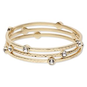 Bracelet, bangle, glass rhinestone and gold-finished "pewter" (zinc-based alloy), clear, 3mm wide with hammered design, 8 inches. Sold per pkg of 3.