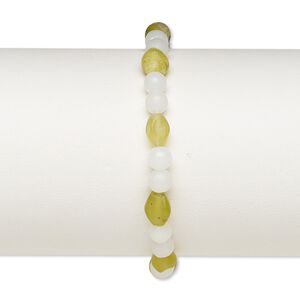 Bracelet, stretch, olive new "jade" (natural) and acrylic, white, 5mm round and 8x6mm-9x7mm oval, 7 inches. Sold individually.