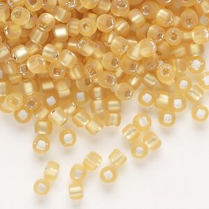 Seed bead, Dyna-Mites™, glass, silver-lined translucent matte medium gold, #6 round with square hole. Sold per 1/2 kilogram pkg.