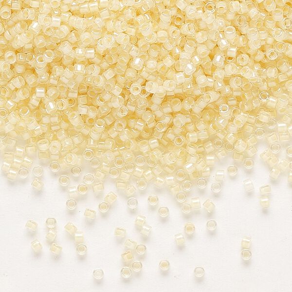 Seed bead, Delica®, glass, pkg/7.5g, #11 round, translucent ivory-lined luster crystal clear (DB-2371). image number 0
