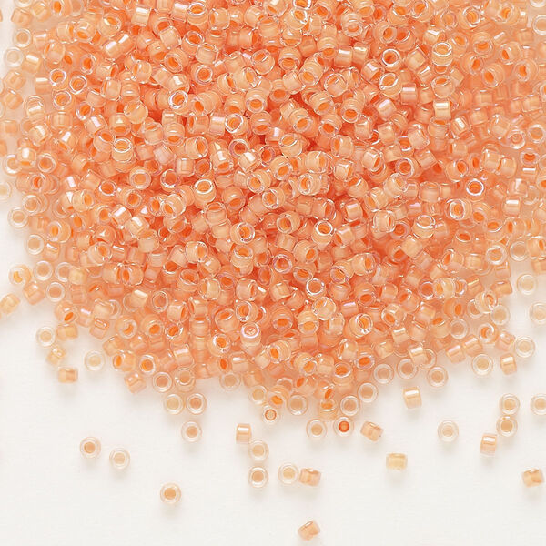 Seed bead, Delica®, glass, pkg/50g, #11 round, translucent peach-lined luster crystal clear (DB-0068). image number 0
