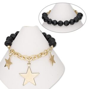 Bracelet, stretch, acrylic and gold-finished steel, black, 9mm faceted round and 26x24mm star, 6-1/2 inches. Sold individually.