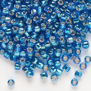 Seed bead, Dyna-Mites™, glass, silver-lined translucent rainbow turquoise blue, #6 round with square hole. Sold per 40-gram pkg.