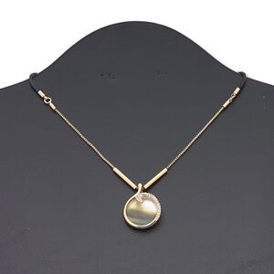 Necklace, black lip shell (natural) / waxed cotton cord / glass rhinestone / copper-finished brass / steel / "pewter" (zinc-based alloy), clear and black, 23mm round, 16 inches with 3-inch extender chain and lobster claw clasp. Sold individually.