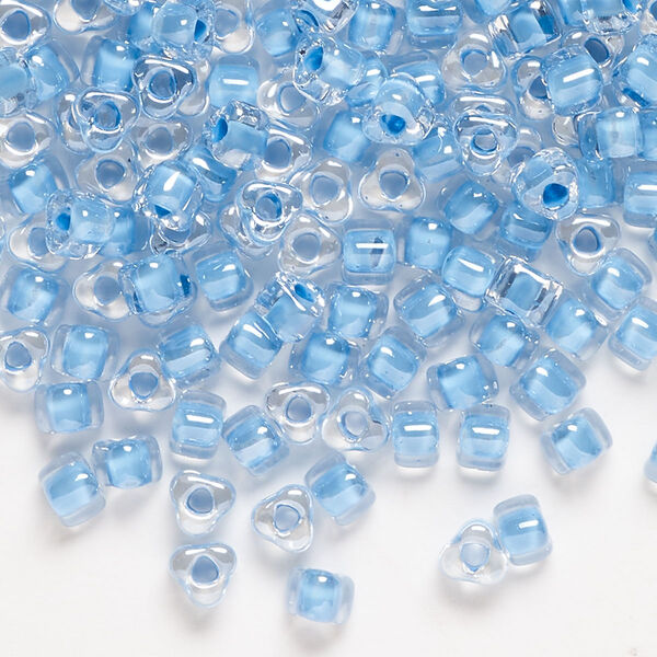 Seed bead, Miyuki, glass, transparent clear color-lined sky blue, (TR1116), #5 triangle. Sold per 250-gram pkg. image number 0