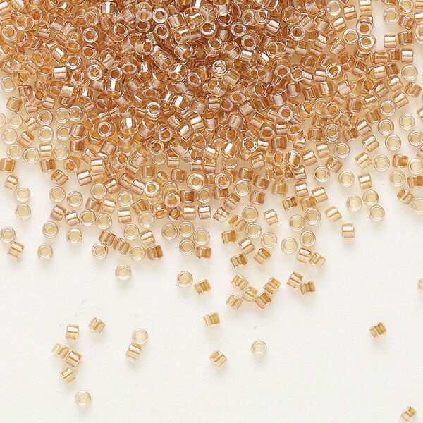 Seed bead, Delica®, glass, pkg/7.5g, #11 round, translucent honey beige-lined luster crystal clear (DB-0901). image number 0