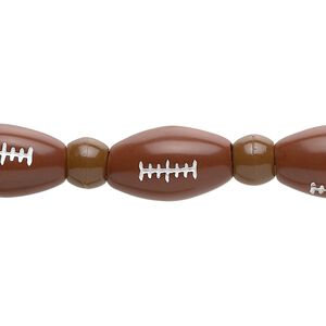 Bead, acrylic, brown and white, 7x5.5mm crow and 17x10mm football. Sold per 11-inch strand.