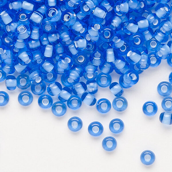Seed bead, Preciosa Ornela, glass, transparent chalkwhite-lined light sapphire, #6 rocaille. Sold per 50-gram pkg. image number 0