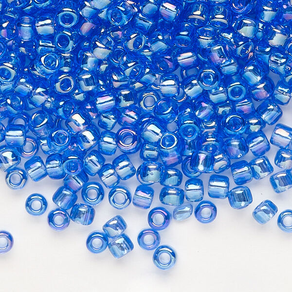 Seed bead, Dyna-Mites™, glass, transparent rainbow medium blue, #6 round. Sold per 40-gram pkg. image number 0