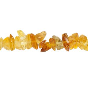 Bead, glass, translucent golden amber, small to extra-large chip. Sold per 30-inch strand.