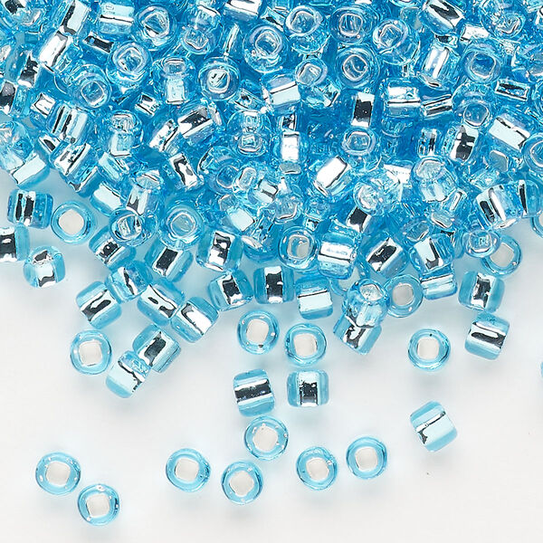 Seed bead, Dyna-Mites™, glass, silver-lined translucent light aqua, #6 round with square hole. Sold per 40-gram pkg. image number 0