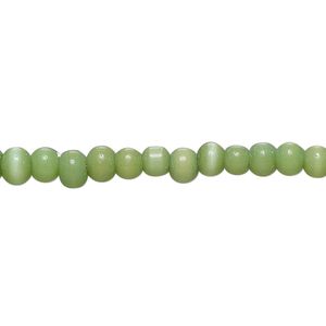 Bead, cat's eye glass (fiber optic glass), green, small pebble. Sold per 14-inch strand.