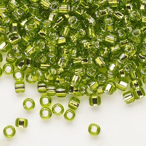 Seed bead, Dyna-Mites™, glass, silver-lined translucent light green, #6 round with square hole. Sold per 1/2 kilogram pkg.