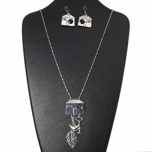 Necklace and earring set, resin / acrylic / silver-finished brass / "pewter" (zinc-based alloy) / steel, black, 32x27mm house, 30 inches with 3-inch extender chain and lobster claw clasp, 1-3/4 inch earrings with fishhook ear wire. Sold per set.