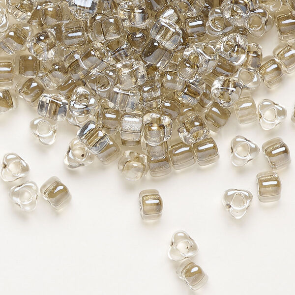 Seed bead, Miyuki, glass, transparent clear color-lined tan, (TR1124), #5 triangle. Sold per 25-gram pkg. image number 0