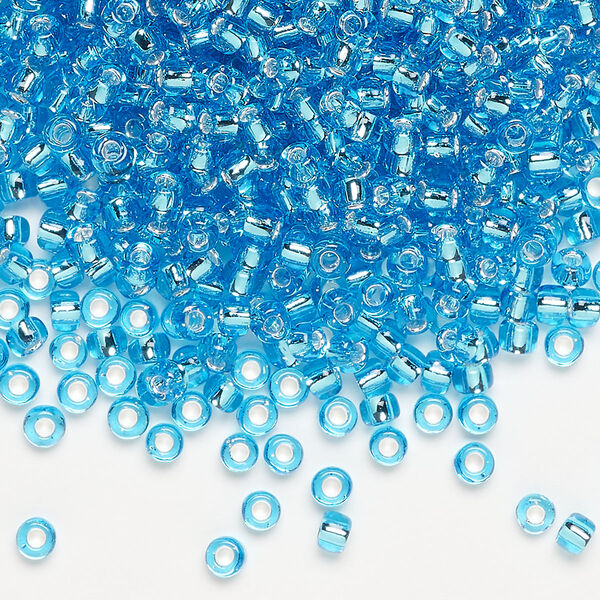 Seed bead, Dyna-Mites™, glass, silver-lined translucent aqua, #8 round. Sold per 40-gram pkg. image number 0