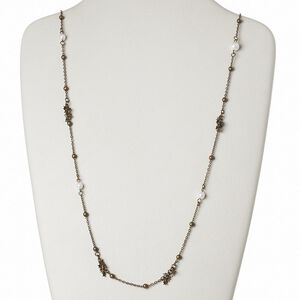 Necklace, acrylic pearl with antiqued brass-finished brass and steel, star, 34 inches with lobster claw clasp. Sold individually.