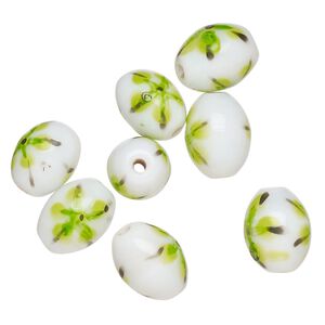 Bead, lampworked glass, opaque white / black / green, 14x11mm-13x10mm oval with painted flower design. Sold per pkg of 8.