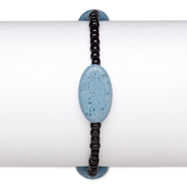 Bracelet, stretch, glass, opaque black and blue, 4x3mm-5x4mm rondelle and 23x13mm-23x14mm puffed oval, 7 inches. Sold individually. image number 0