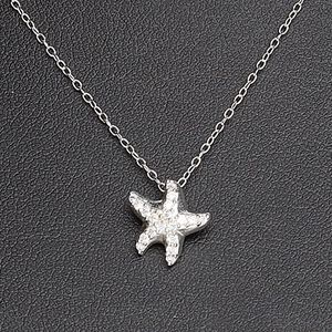 Necklace, Create Compliments®, cubic zirconia and sterling silver, clear, 11mm starfish, 18 inches with springring clasp. Sold individually.