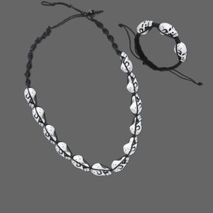 Necklace and bracelet, wood (dyed) / waxed cotton cord / acrylic, black and white, skull, 20-inch necklace with button-style clasp and 6-1/2 to 10-inch bracelet with button-style clasp. Sold per set.