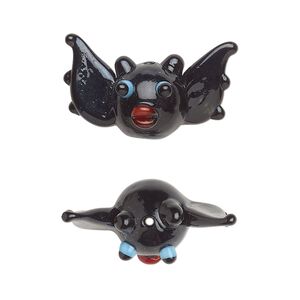 Bead, lampworked glass, opaque black / red / blue, 25x13mm bat. Sold individually.